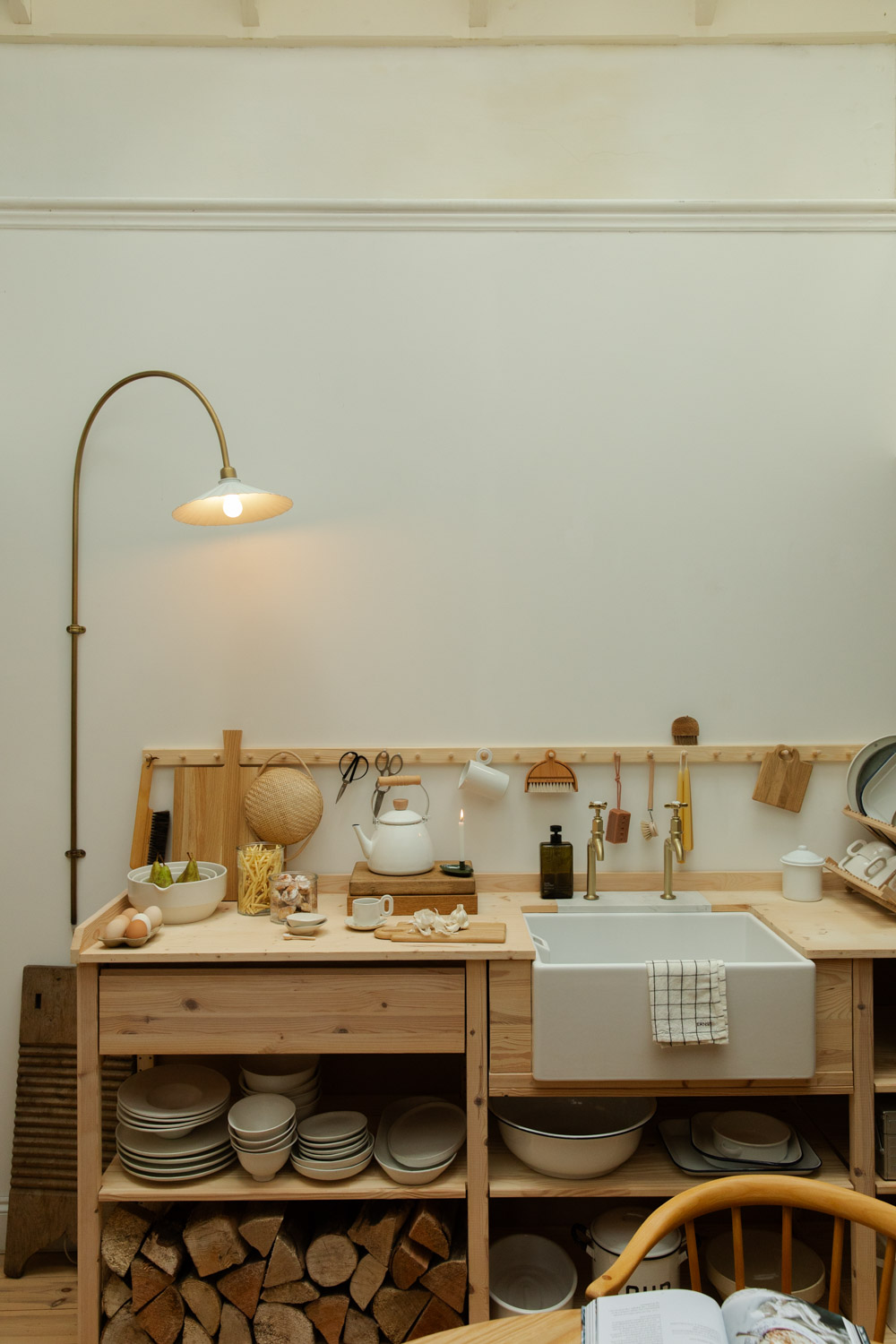 Scandinavian style wooden kitchen worktop with peg rail and beautful kitchen items.